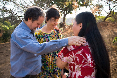 Shu-Mei praying with the Webers