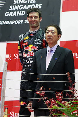 Марк Уэббер поглядывает на предствителя Сингапура на подиуме Гран-при Сингапура 2011
