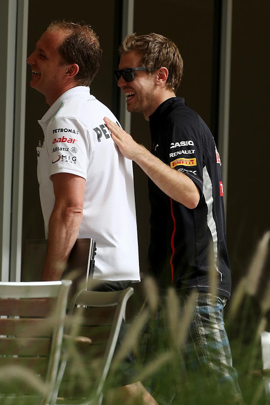 Себастьян Феттель хлопает по спине механика Mercedes на Гран-при Бахрейна 2012