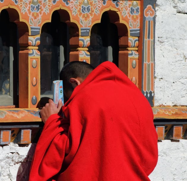Monk prays at Simtokha Dzong, Bhutan