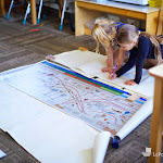 Working together on big projects is a key part of the Montessori elementary program. Here, several students are doing a follow-on work on the Great Story of the Coming of Life.