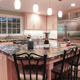 Bushman Kitchen 1 of 5 - This beautiful, large kitchen got a complete facelift with natural maple cabinets, stainless steel appliances, granite countertops, stone backsplash, and updated lighting.
