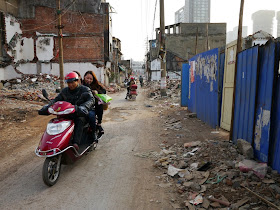 man and two women riding on a motorbike at Beizheng Street in Changsha