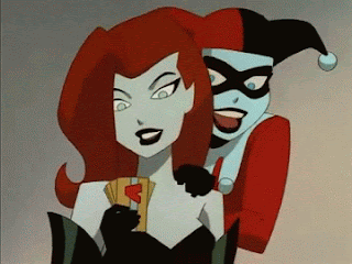 moving image. Harley holding onto Ivy as Ivy displays credit cards like a hand of playing cards 