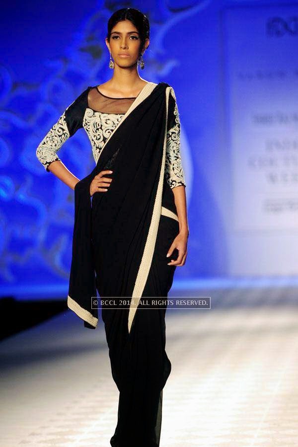 A model walks the ramp for Varun Bahl walks the ramp on Day 3 of India Couture Week, 2014, held at Taj Palace hotel, New Delhi.