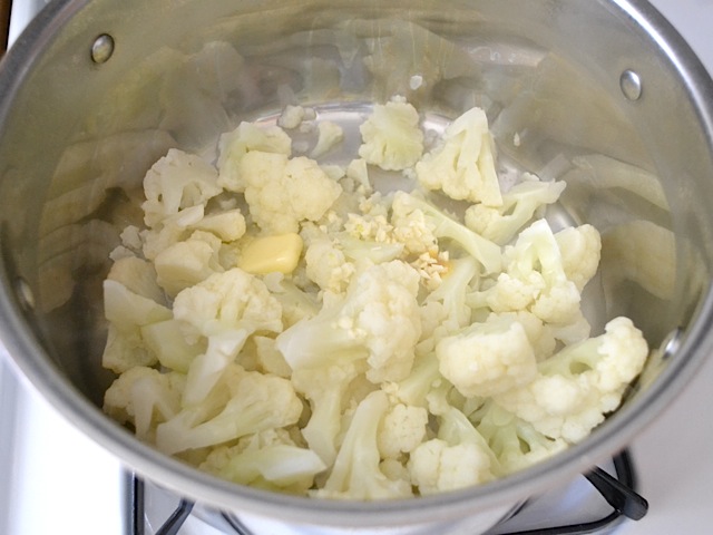 cauliflower cooking in pot of boiling water 
