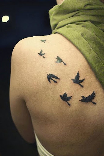 flying birds tattoos on upper back of women