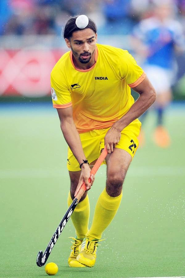 Akashdeep Singh of India runs with the ball during a men's field hockey match between India and Scotland at the Glasgow National Hockey Centre at the 2014 Commonwealth Games, in Glasgow, on July 26, 2014.