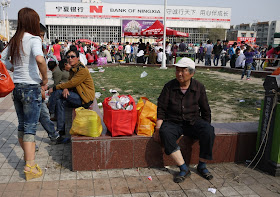 woman sitting at Nanmen Square in Yinchuan, Ningxia, China