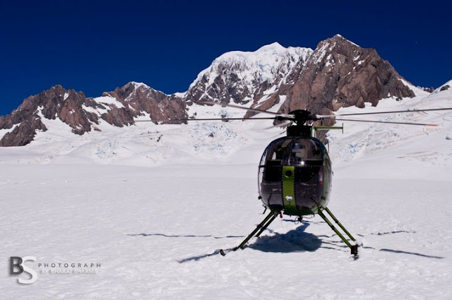 Breathtaking helicopter flights exposing the magnificent views of the pristine alpine environment in the AorakiMount Cook World Heritage Park - By BHARAT SHARMA : Aoraki / Mount Cook is the highest mountain in New Zealand at a height of 3800 metres (~12400ft). Mount Cook lies in the Southern Alps and its the mountain range which runs the length of the South Island. recently Bharat visited the place through Helicopter and it must a wonderful ride for the sweet couple.. Check out some of the photographs clicked by Bharat's Travelling Camera....Mr. Bharat Sharma - An enthusiastic Travel Photographer !!!He is currently exploring various regions of New Zealand and this time decided to have a helicopter ride to Aoraki / Mount Cook...The mountains is in the Aoraki / Mount Cook National Park were gazetted in 1953 and along with Westland National Park, Mount Aspiring National Park and Fiordland National Park forms one of the UNESCO World Heritage Sites !!! The park contains more than 135 peaks standing over 1900 metres and 72 named glaciers, which cover 40 percent of the park's 700 square kilometers...Bharat and Ishita @ Aoraki / Mount Cook, New Zealand !!!There are lot activities available here for tourists and people come here many times to enjoy special moments of these mountains... And these mountains seems changed everytime...Aoraki / Mount Cook consists of three summits lying slightly south and east of the main divide, the Low Peak, Middle Peak and High Peak, with the Tasman Glacier to the east and the Hooker Glacier to the west.Aoraki / Mount Cook : Helicopter waiting for back journey !!!Apart from being apopular tourist destination it is also a favourite challenge for mountain climbers. 