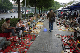 various items on the ground for sale outside Tianxinge Antique City in Changsha, China