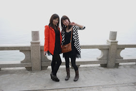 two young ladies posing in front of sea in Zhuhai