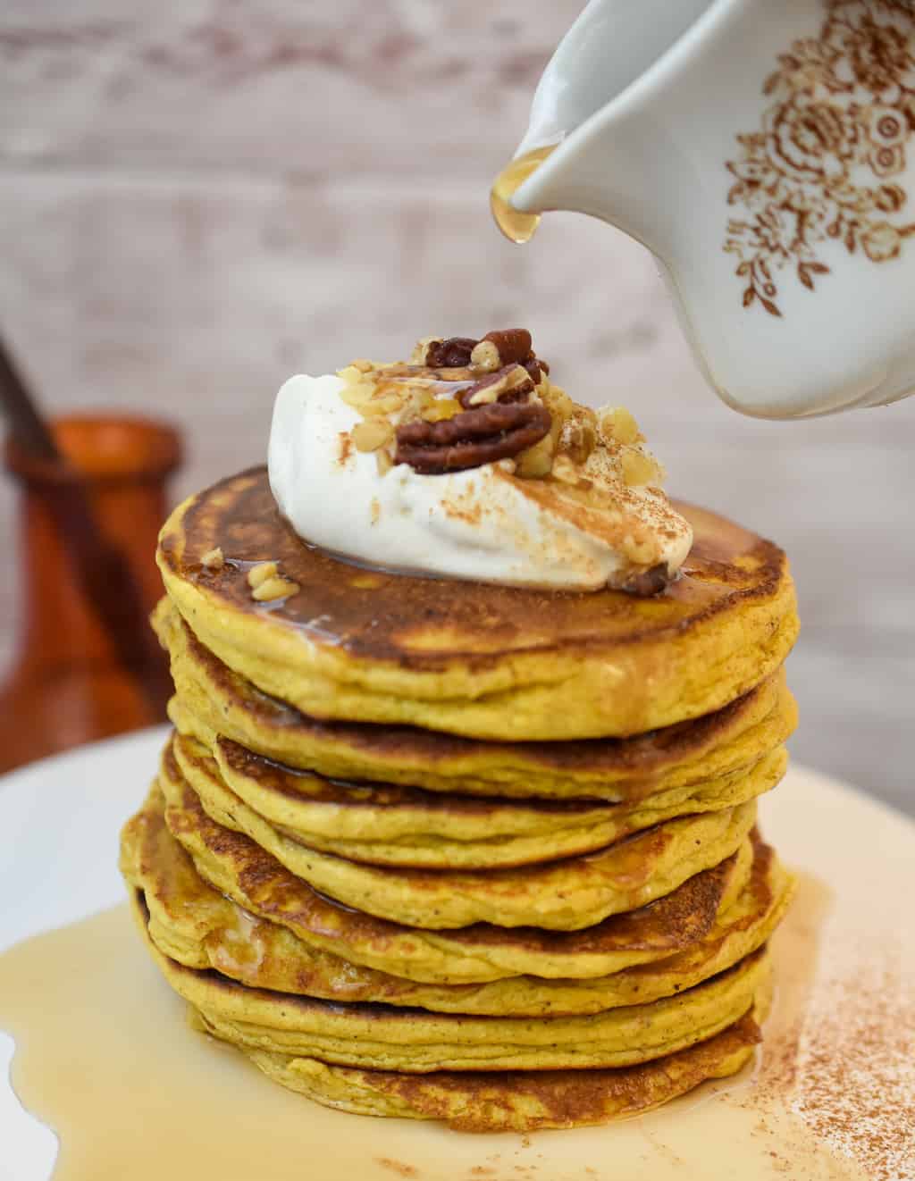 keto pumpkin pancakes topped with cream cheese whipped cream