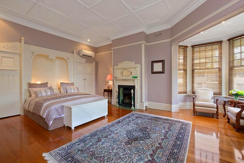 The ornate ceilings, picture rails, high skirting boards and bay window are exemplary of Federation Queen Anne style. The closets are also ornamental in a flowing Art Nouveau design, very unusual to have built-in wardrobes, let alone designed with such beautiful decorative style.