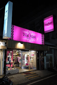 small lingerie store named Wal Mart with pink sign