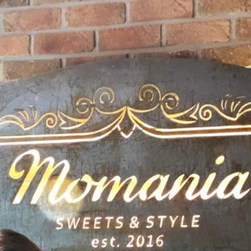 Momania Concept Store & Café logo