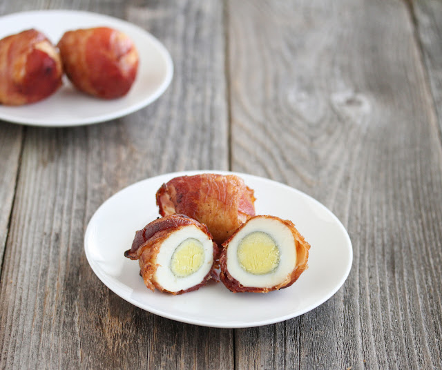 two plates of Baked Bacon Wrapped Eggs