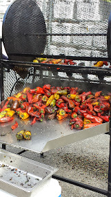 Organic Roasted Chli Peppers from Westwind Gardens, Forest Grove, OR at Portland Farmers Market PSU in autumn. The aroma of the freshly roasting peppers is incredible