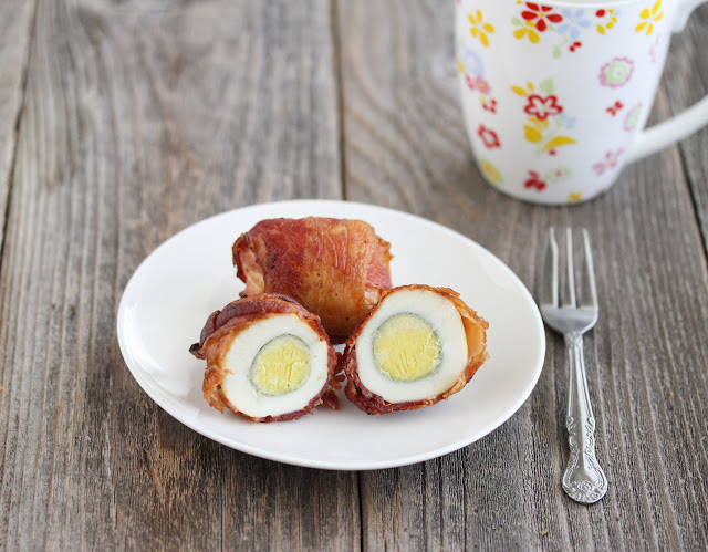 baked bacon wrapped egg sliced in half