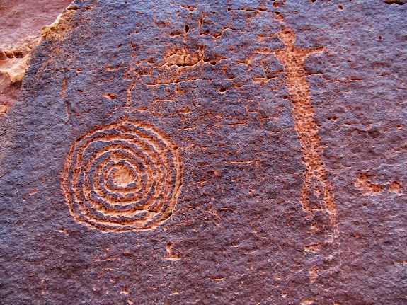 Human figure and spiral or snake