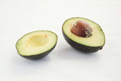 photo of an avocado sliced in half