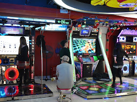people playing dance video games in D-Mall in Shanghai