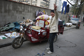 man in front of his motor tricycle cart in Changsha, China