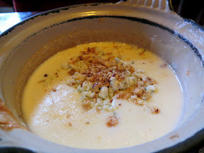 Urban Fondue, Portland, fondue restaurant, cheese fondue for two of Brie and Gorgonzola, with Brie cheese swirled with Gorgonzola cheese and topped with roasted hazelnuts