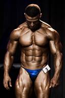 Sexy Competitive Male Bodybuilder Posing on Stage