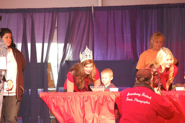 The Festival Queen gives a pep talk to a wee strawberry stemmer