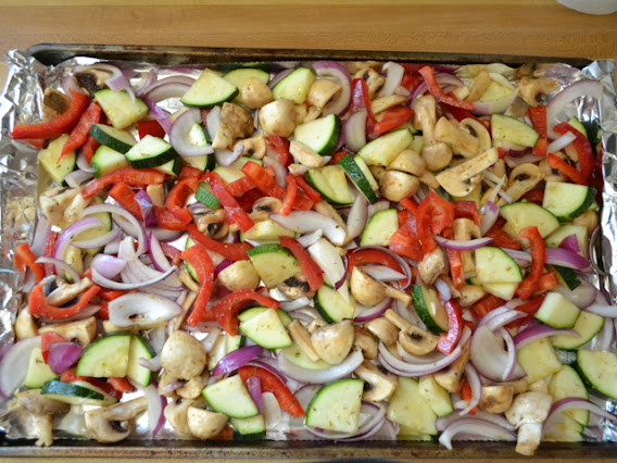 veggies spread out on baking sheet covered in tin foil 