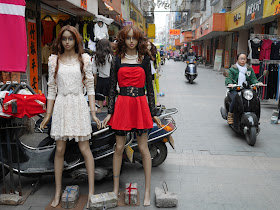 mannequins and woman on a motorbike in Yangjiang, China
