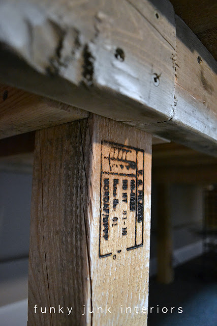 Pallet markings on these desk legs share the reclaimed wood details on this magnificent 12 foot desk build!
