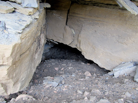 Buried mine entrance with a hole large enough to crawl through
