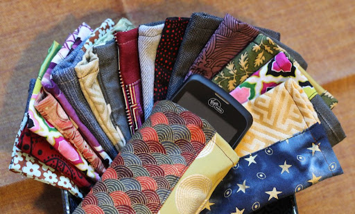 a collection of little smartphone pouches in various different fabrics