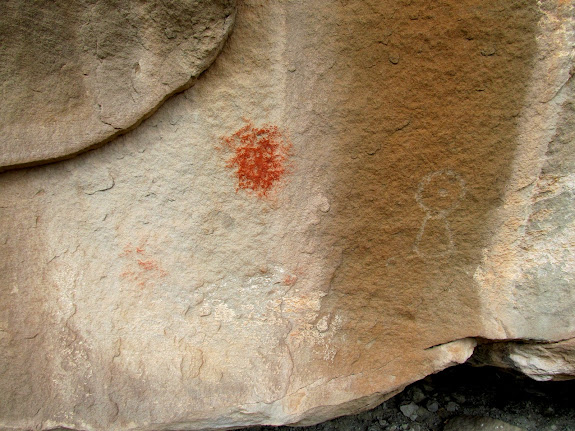 Smudges of pigment and a petroglyph