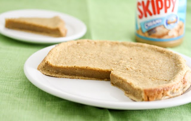 photo of a flourless peanut butter cake with two slices removed