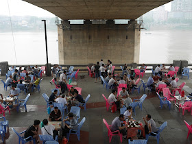 people playing cards and drinking tea under a bridge in Hengyang, Hunan, China