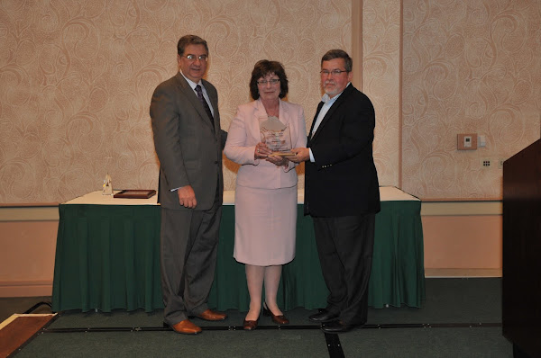 Kathleen Guarino, Vice President of Patient Care Services and Chief Nursing Officer at Mercy Hospital of Buffalo/Catholic Health System, accepts the 2011 Pinnacle Award for Quality and Patient Safety (Small Hospital category). Handing out the award are HANYS President Daniel Sisto (left) and Joseph McDonald, President and Chief Executive Officer of Catholic Health System (right).