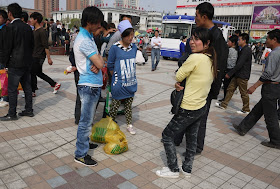 several people standing and talking at Nanmen Square in Yinchuan, Ningxia, China