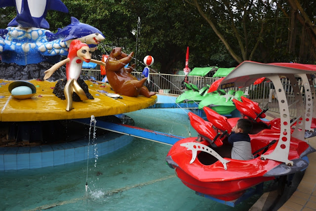 Boy on water shooting amusement park ride in Zhuhai, China
