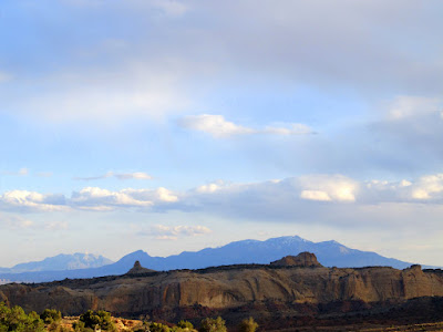 San Rafael Reef highlighted by the Henry Mountains in the background
