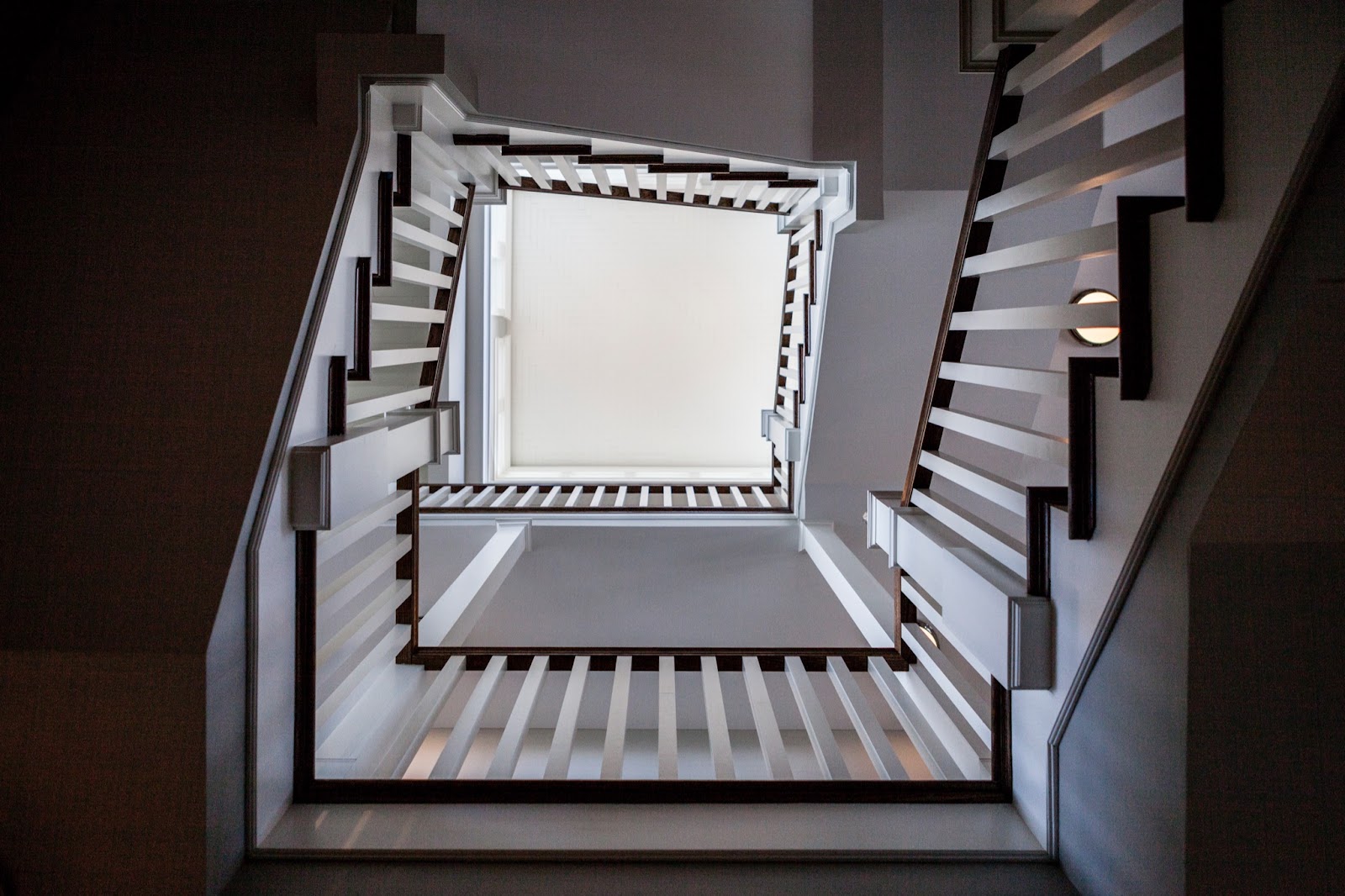 Artistic view of an open, winding staircase looking from ground floor up