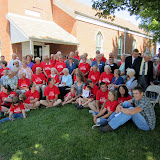 The congregation gathers for a group photo in front of the church.