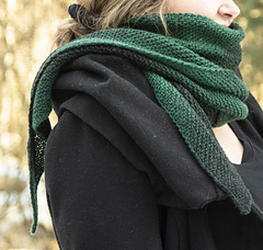 woman wearing green reversible knit scarf wrapped around neck