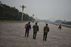 three men walking at Tiananmen Square