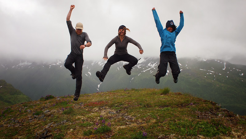 Members of a mountain goat research crew kick up their heels at Kodiak Refuge, AK.
