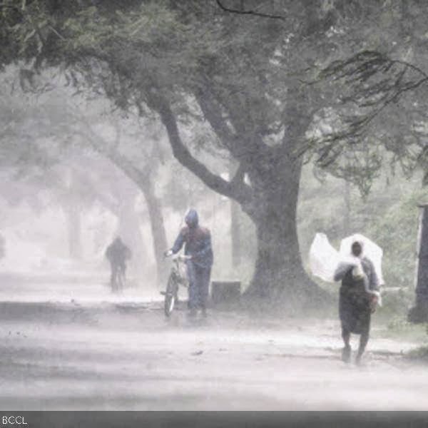 A man covers himself with a plastic sheet as a shield from the rain as he walks to a safer place near Gopalpur junction in Ganjam district about 200 kilometers (125 miles) from the eastern Indian city Bhubaneswar.