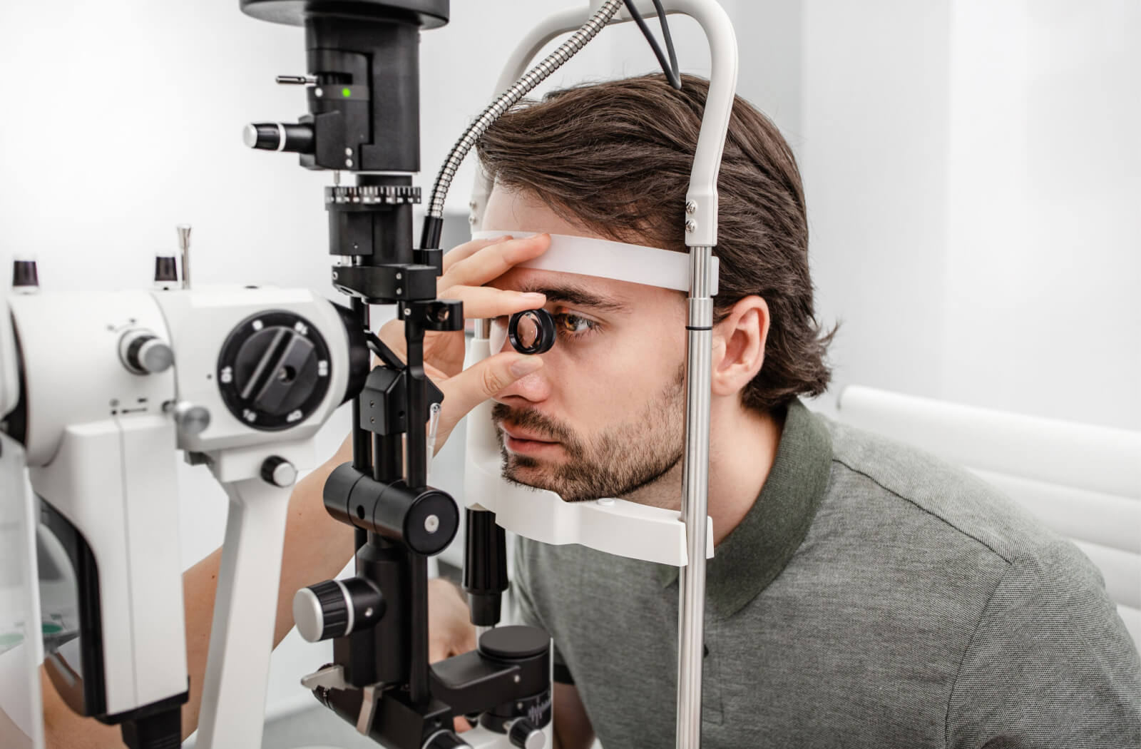A man is undergoing an eye check with the slit lamp. He regularly has his eyes checked as he age.