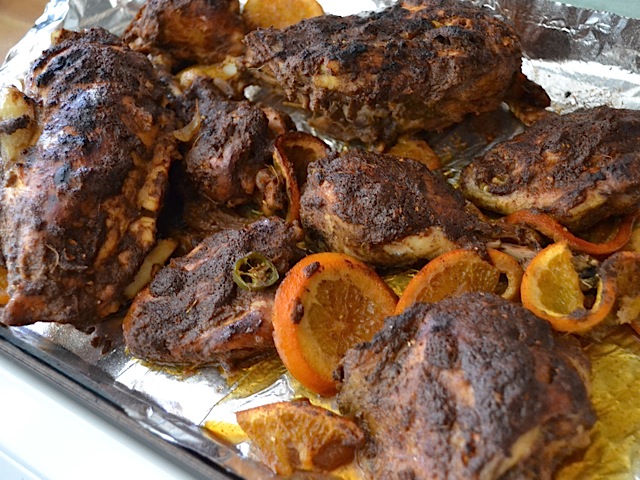 broiled and browned  jerk chicken on baking sheet 